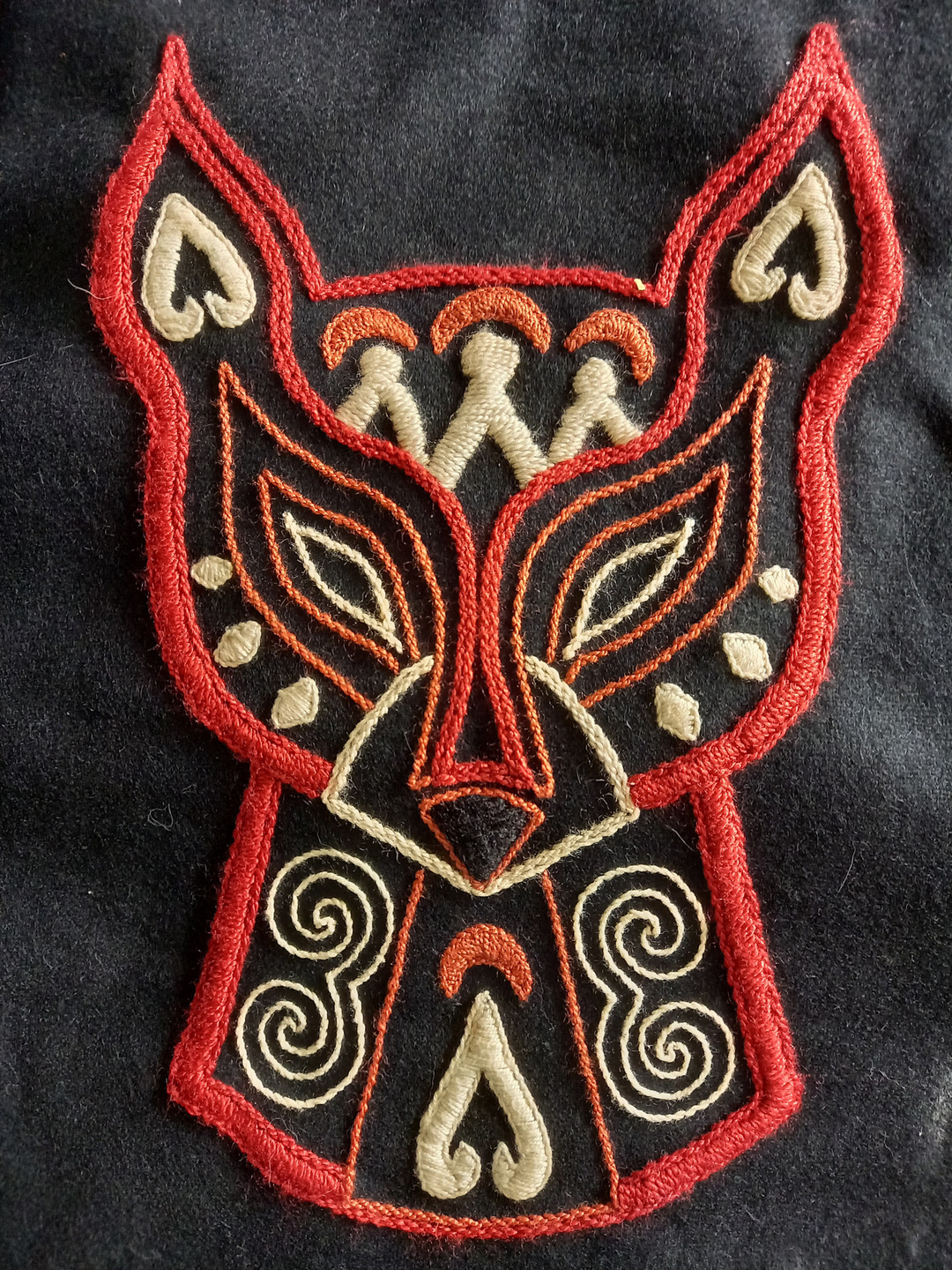 A close up on the fox head motif on the back of the traditional Nanai coat.